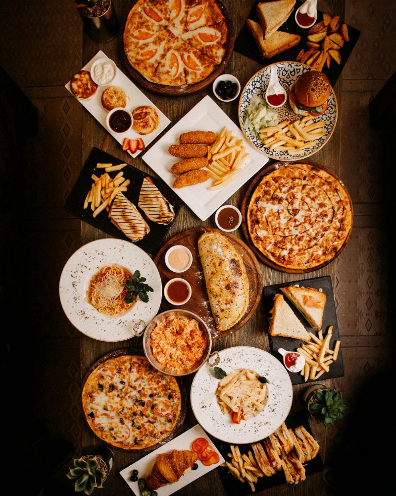 top-view-meals-tasty-yummy-different-pastries-dishes-brown-surface